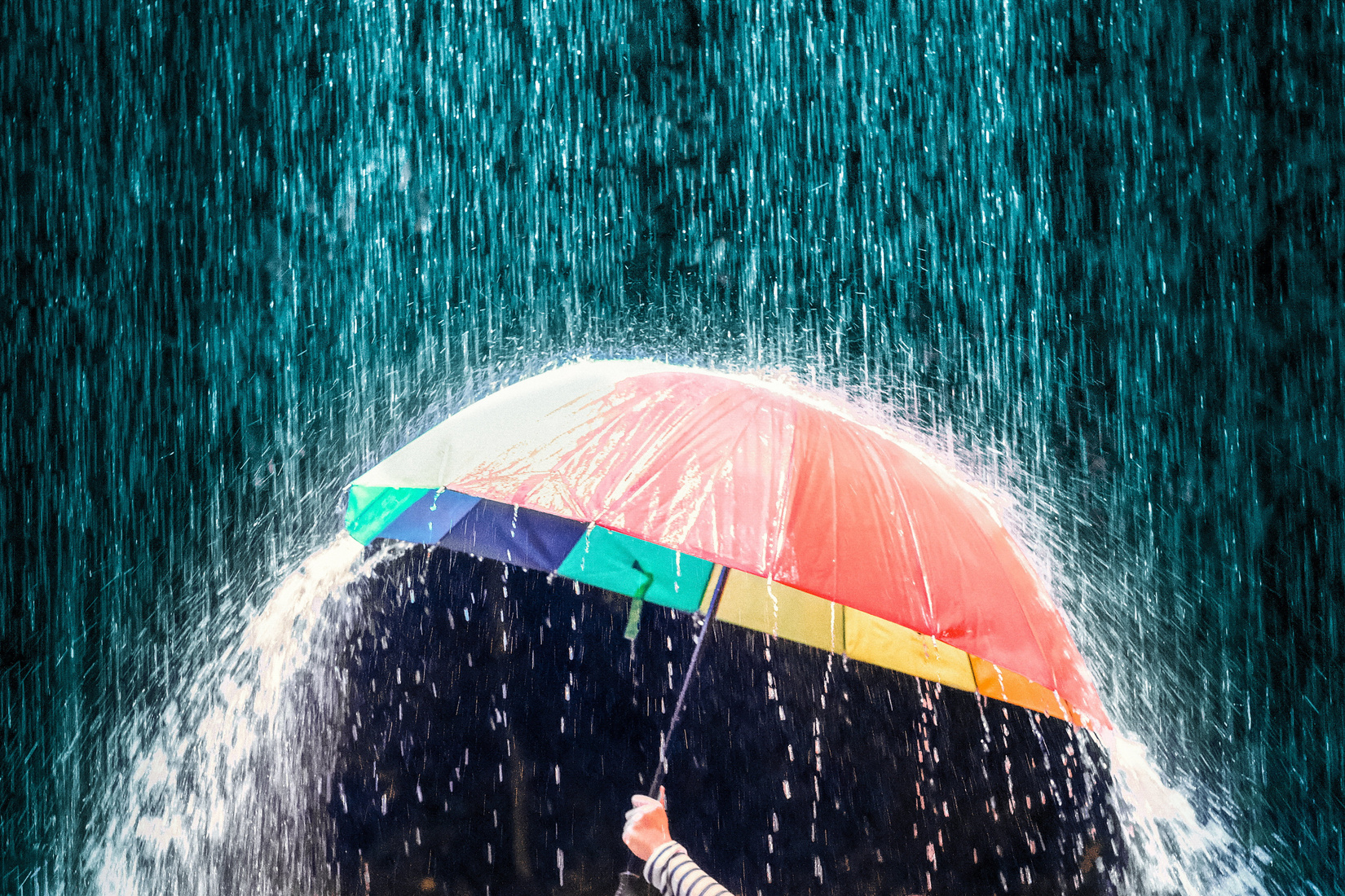 Colorful umbrella under the rain 